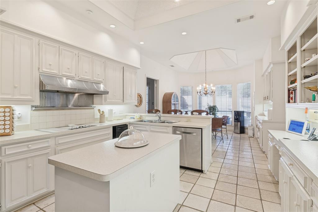 Kitchen featuring white cabinetry, center island, stainless steel range hood, tile flooring, and recessed lighting