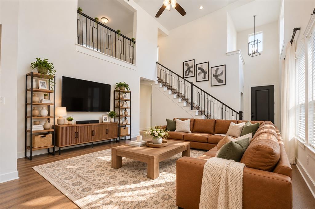 Spacious open-concept living room with soaring ceilings, abundant natural light, and seamless flow into the kitchen and dining areas. Spacious open-concept living room with soaring ceilings, abundant natural light, and seamless flow into the kitchen and dining areas.