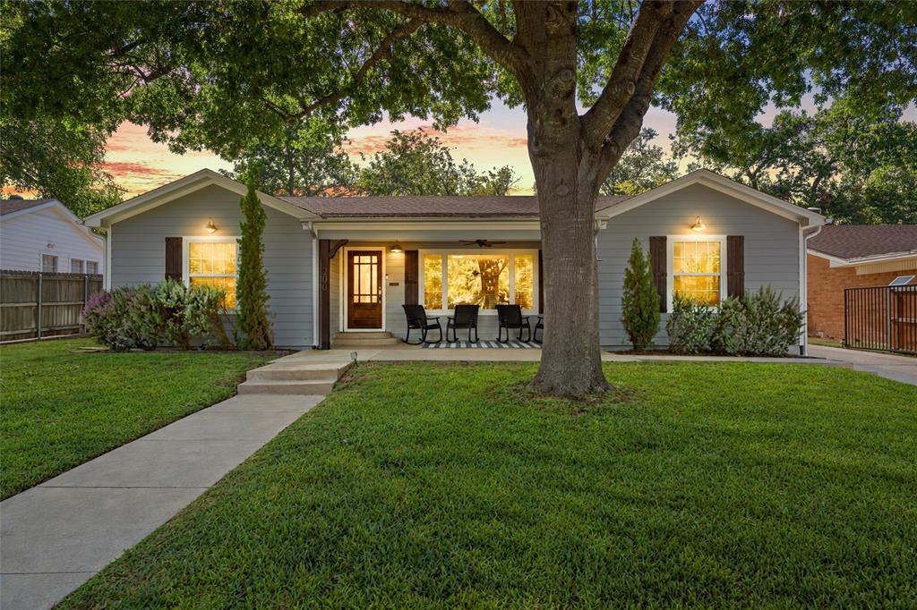 Single-story exterior featuring horizontal siding, dark-toned shutters, a covered front porch, and a concrete walkway