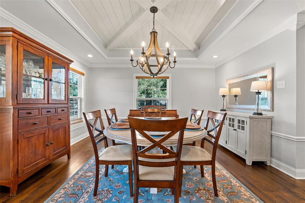 Dining space featuring a coffered ceiling with a central cross-beam design, a multi-arm iron chandelier, wood-finish flooring, and crown molding