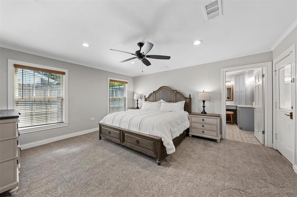Neutral-toned interior featuring wall-to-wall carpeting, recessed lighting, crown molding, a central ceiling fan, and dual windows