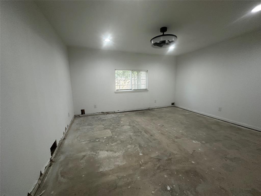 Interior space featuring neutral wall paint, recessed lighting, a ceiling-mounted light fixture, and a sliding window Interior space featuring neutral wall paint, recessed lighting, a ceiling-mounted light fixture, and a sliding window