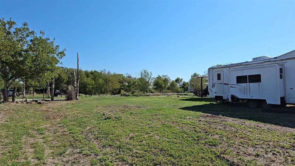 Expansive lot featuring mature trees, cleared land, and open green space