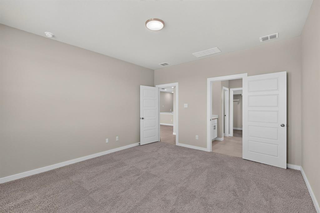 Neutral-toned interior featuring wall-to-wall carpeting, five-panel interior doors, and a central ceiling-mounted flush light fixture