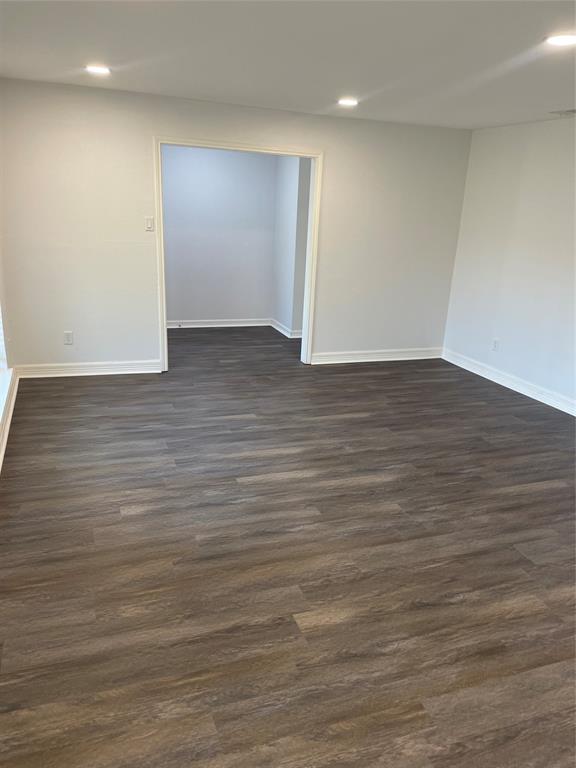 Neutral wall tones, wood-finish flooring, and recessed ceiling lighting