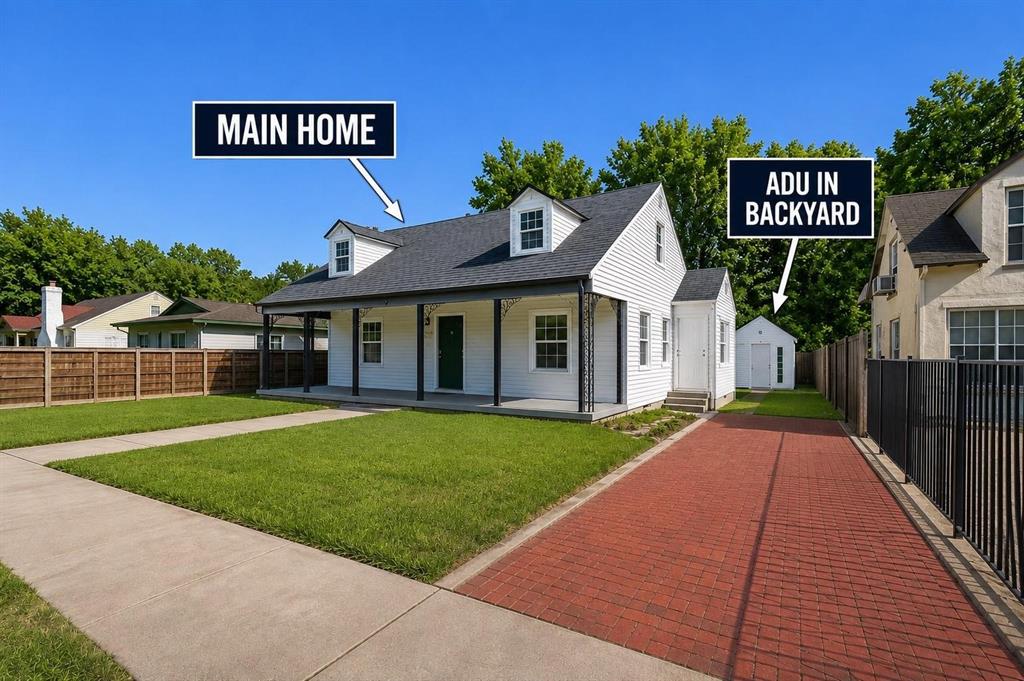 Cape Cod architecture featuring a covered front porch, white lap siding, dual dormer windows, and a separate detached unit Cape Cod architecture featuring a covered front porch, white lap siding, dual dormer windows, and a separate detached unit