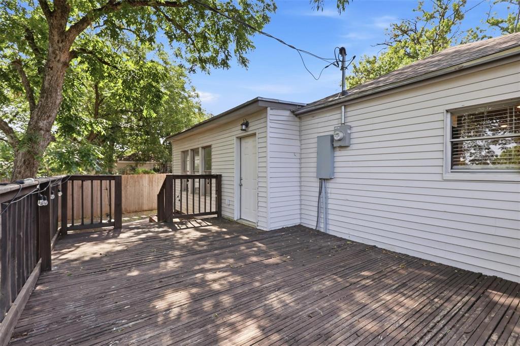 Exterior deck featuring horizontal wood-plank decking, wood railing, and siding construction