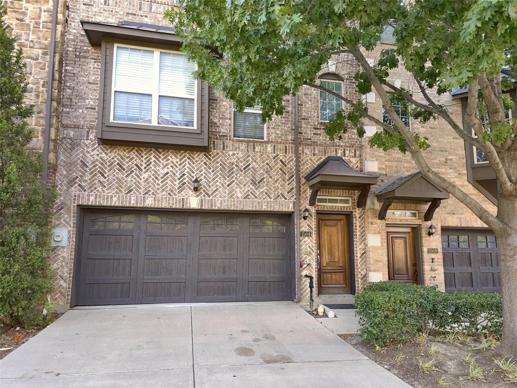 Multi-story brick exterior featuring herringbone masonry detailing, a two-car garage with overhead carriage-style doors, wooden entry doors, and metal-covered entry overhangs Multi-story brick exterior featuring herringbone masonry detailing, a two-car garage with overhead carriage-style doors, wooden entry doors, and metal-covered entry overhangs