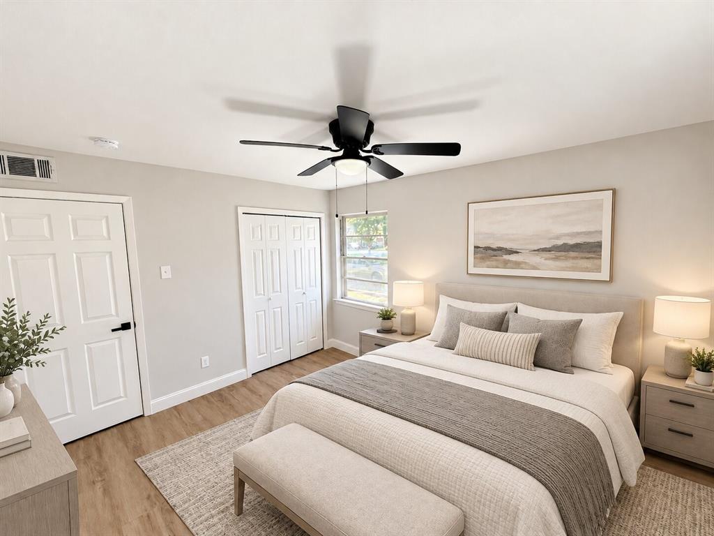 Wood-finish flooring, neutral wall tones, multi-panel doors, closet with bifold doors, and a ceiling fan with integrated lighting