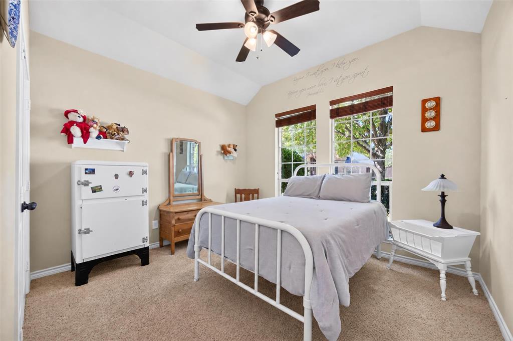 Vaulted ceiling with an integrated three-blade ceiling fan and light fixture, featuring dual multi-pane windows with wood-finish blinds
