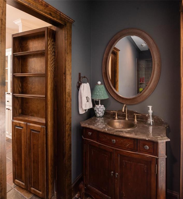 Full bathroom with hidden door off of game room