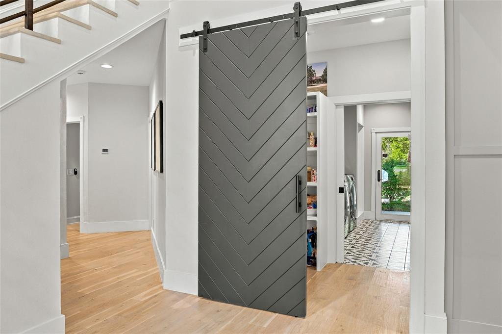 Large Walk-in Pantry which leads to separate laundry room including ice maker, dog shower, & door to exterior