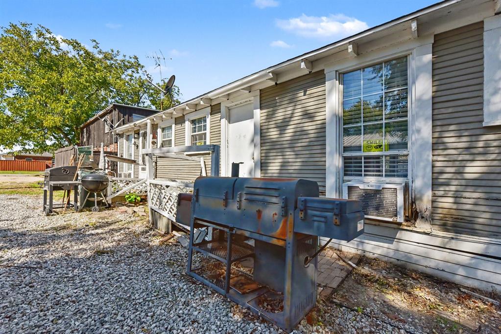 Horizontal lap siding exterior with multi-pane windows and a gravel ground surface