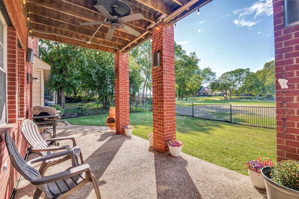 A covered back patio has room for outdoor dining and entertaining, while the expansive fairway and mature trees create a picturesque backdrop for relaxing and enjoying the scenery.