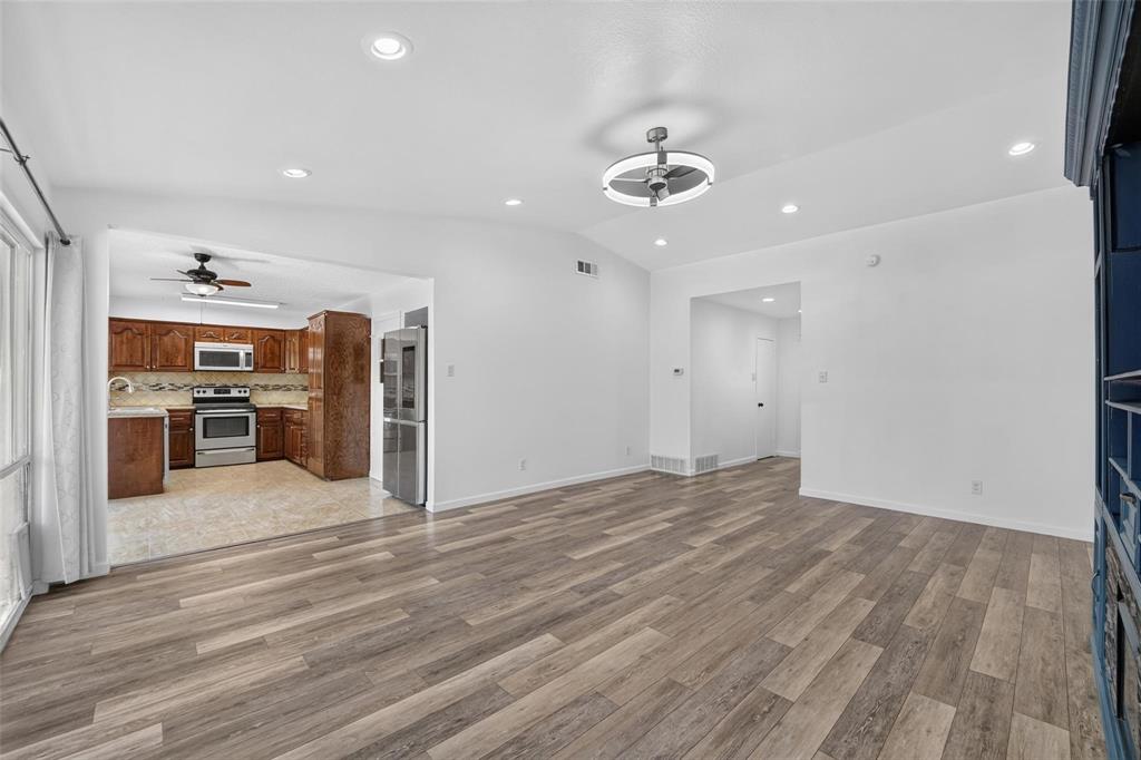 Open-concept interior featuring wood-finish flooring, recessed lighting, and a modern ceiling fan