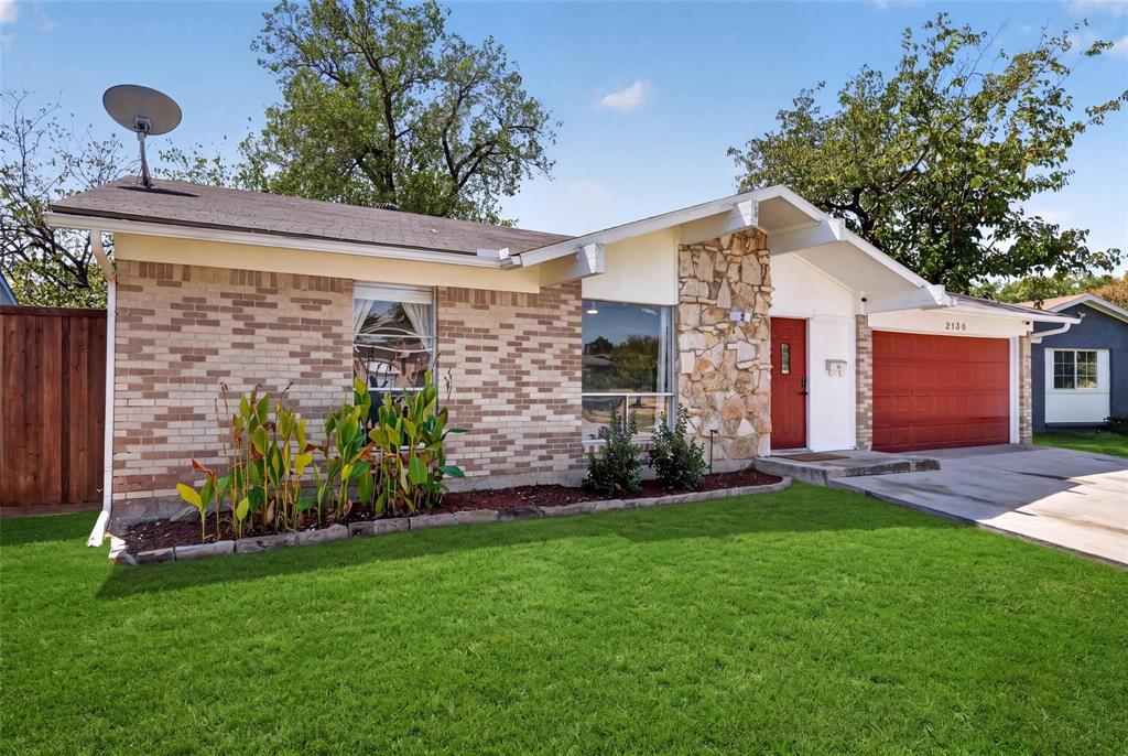 Single-story exterior featuring multi-toned brick masonry, natural stone accent facade, prominent gabled roofline, and attached two-car garage Single-story exterior featuring multi-toned brick masonry, natural stone accent facade, prominent gabled roofline, and attached two-car garage
