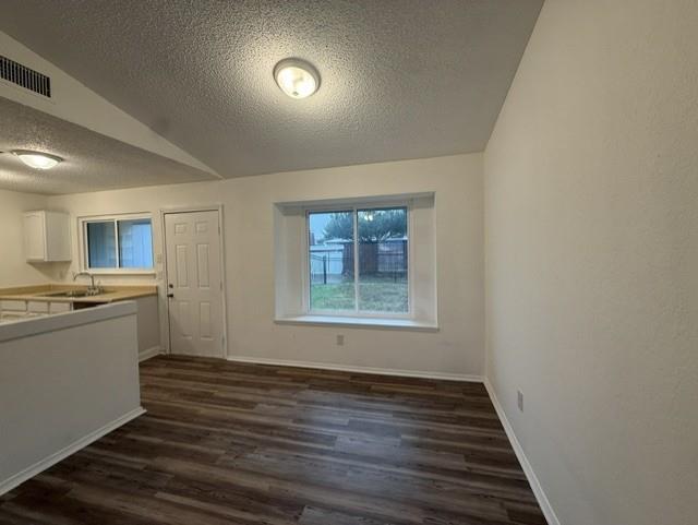 Wood-finish flooring, recessed lighting, and a prominent bay window with a wide sill Wood-finish flooring, recessed lighting, and a prominent bay window with a wide sill