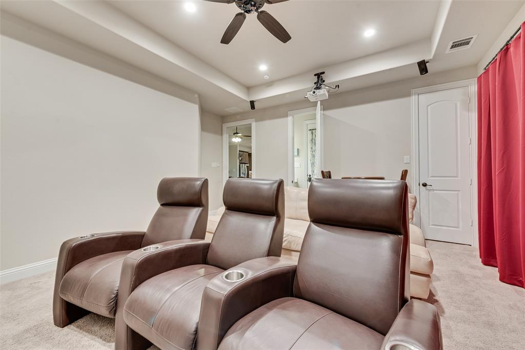 Tray ceiling with recessed lighting, integrated ceiling fan, and ceiling-mounted projector