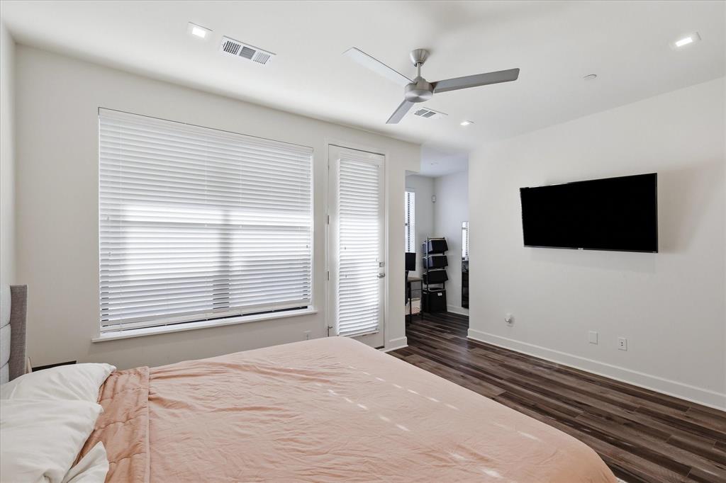 Bedroom featuring wood-finish flooring, recessed lighting, a ceiling fan, a window with horizontal blinds, and a glass-paneled exterior door