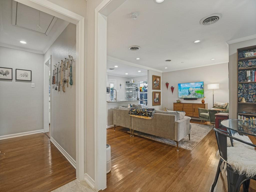 Interior space featuring wood-finish flooring, recessed lighting, and built-in floor-to-ceiling shelving