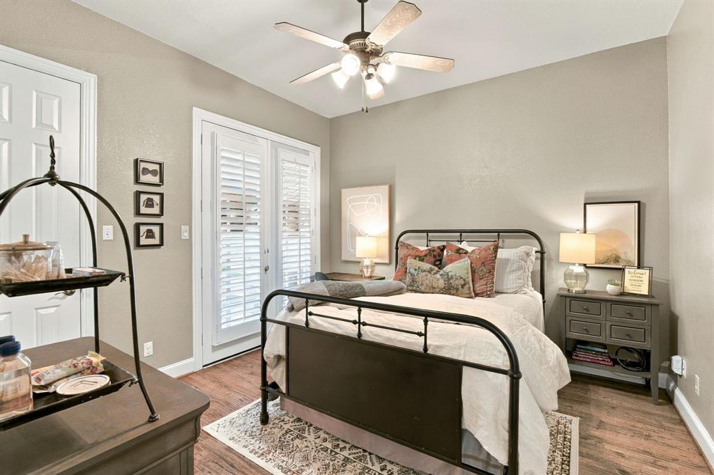 French doors with white plantation shutters, wood-finish flooring, and a multi-light ceiling fan