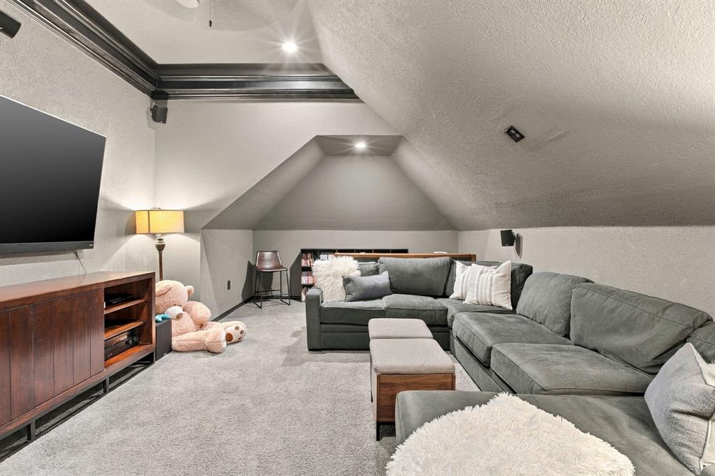 Vaulted ceiling, recessed lighting, and dark crown molding