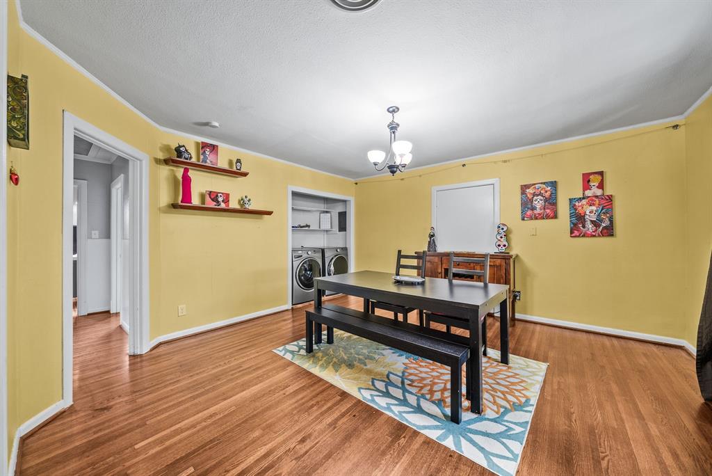Wood-finish flooring throughout, with a recessed laundry area