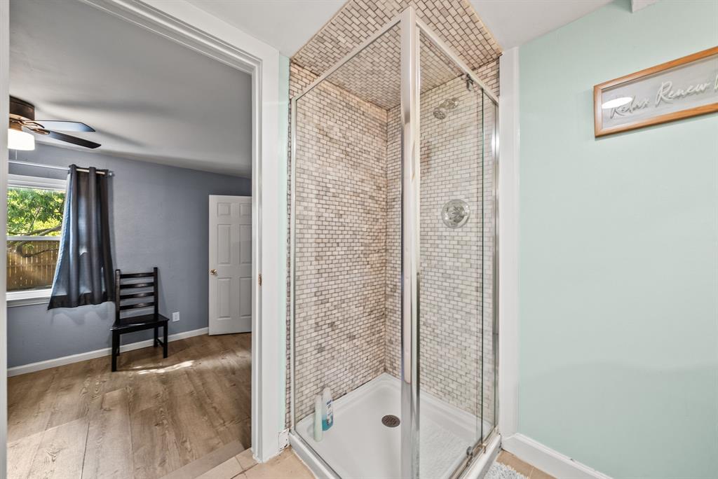 Enclosed shower with subway tile surround and clear glass door