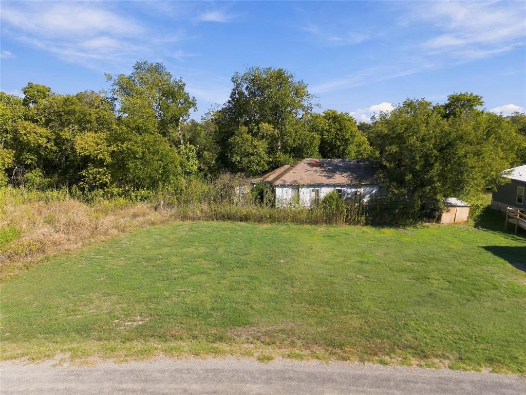 Expansive lot featuring open lawn area and mature trees