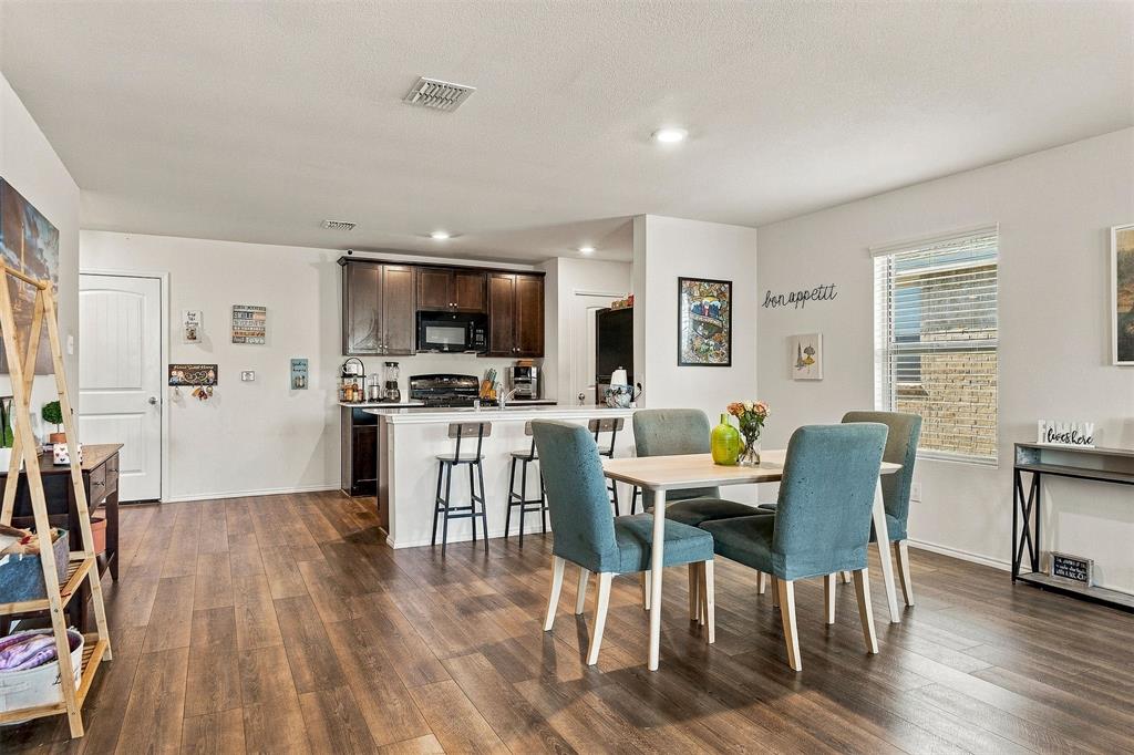 Dedicated dining space conveniently located between the kitchen and living room.