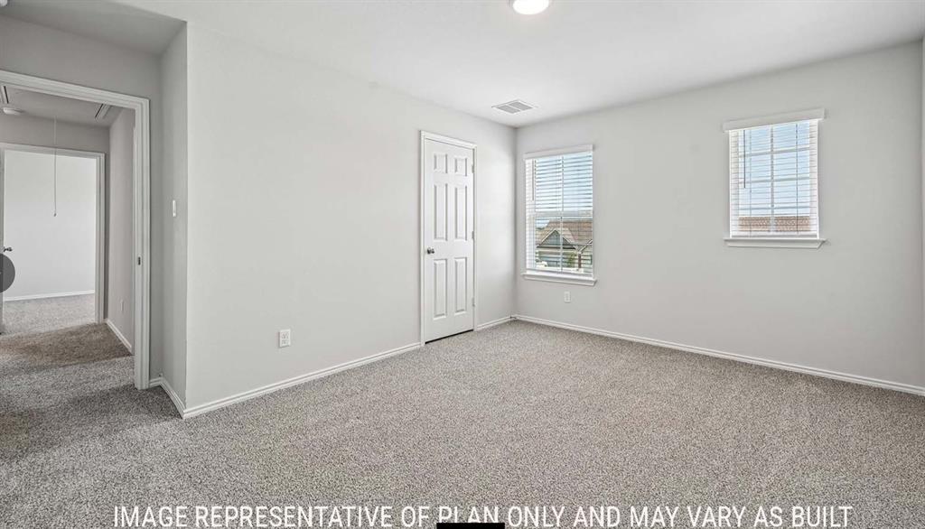 Neutral wall color, carpeted flooring, two windows with blinds, and a paneled interior door