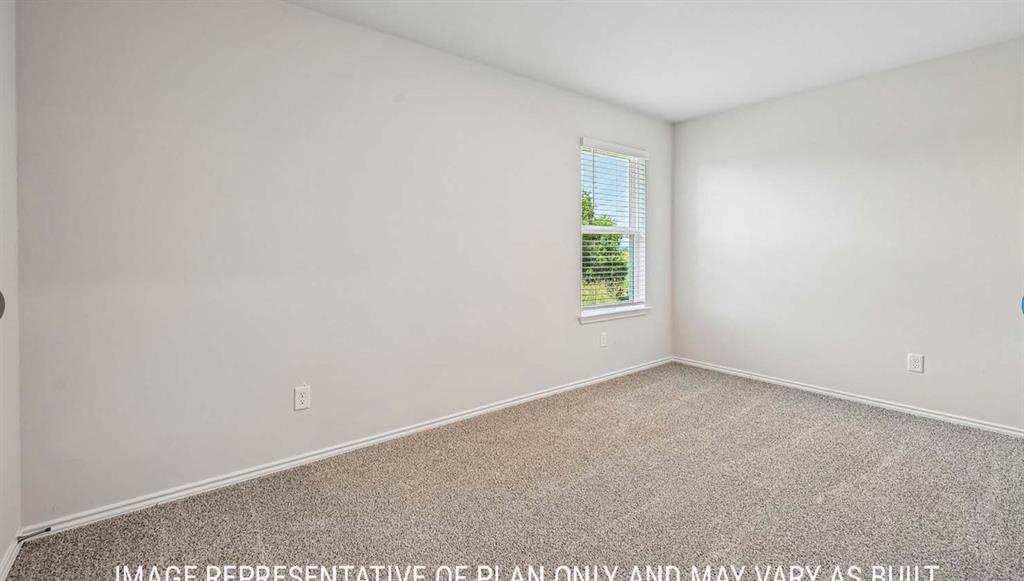 Neutral-toned interior space featuring wall-to-wall carpeting and a single-hung window with blinds