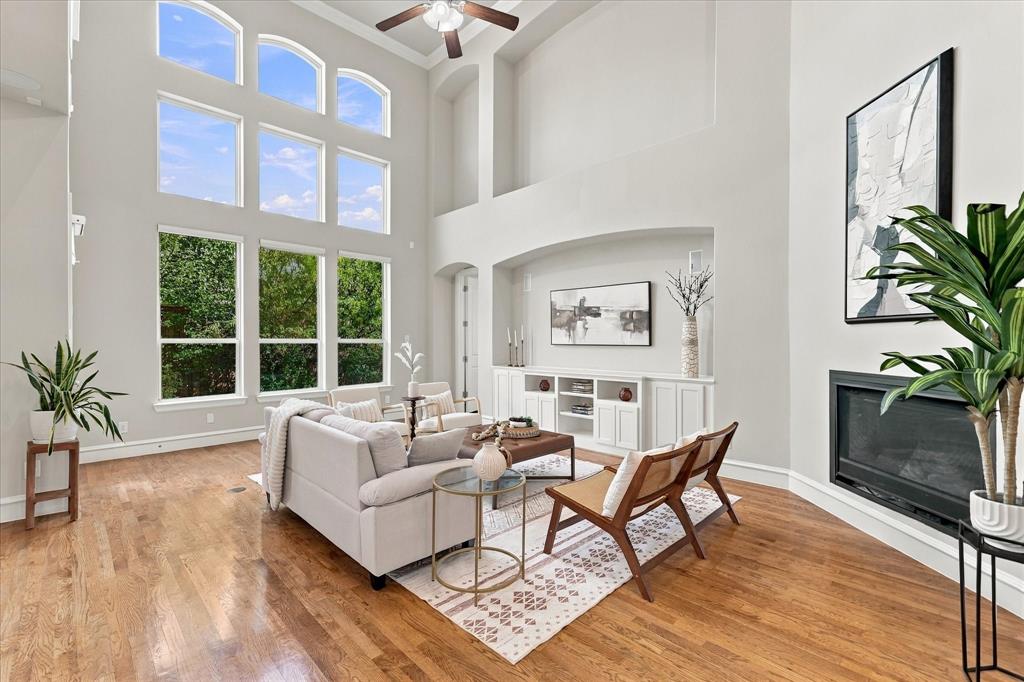 Living Room with vaulted ceilings and wall of windows providing ample natural light. LED ceiling lights installed, removes the need to change bulbs