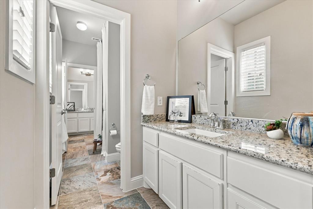 Jack and Jill bathroom with granite counters