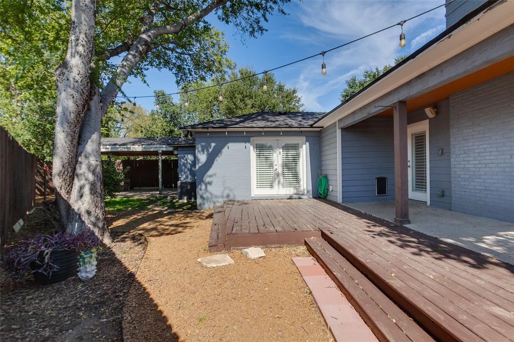 Backyard deck and patio showing carport in background