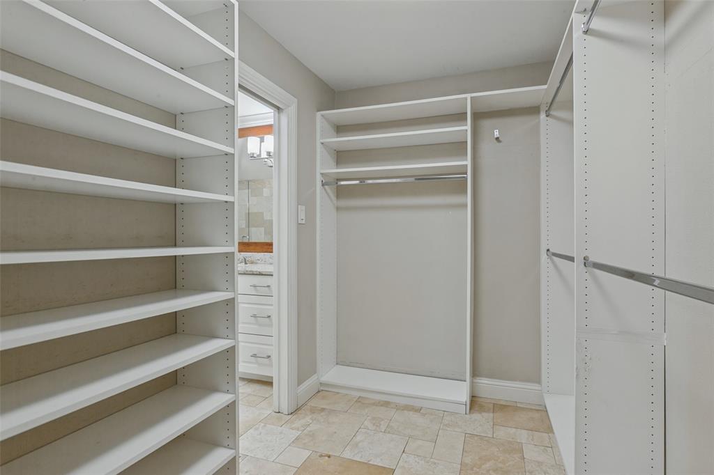Custom closet system in walk-in primary closet