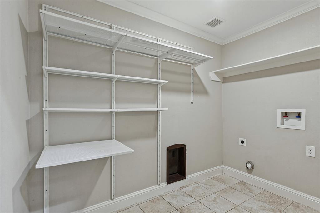 Hallway utility room has ample storage and space for full size washer & dryer