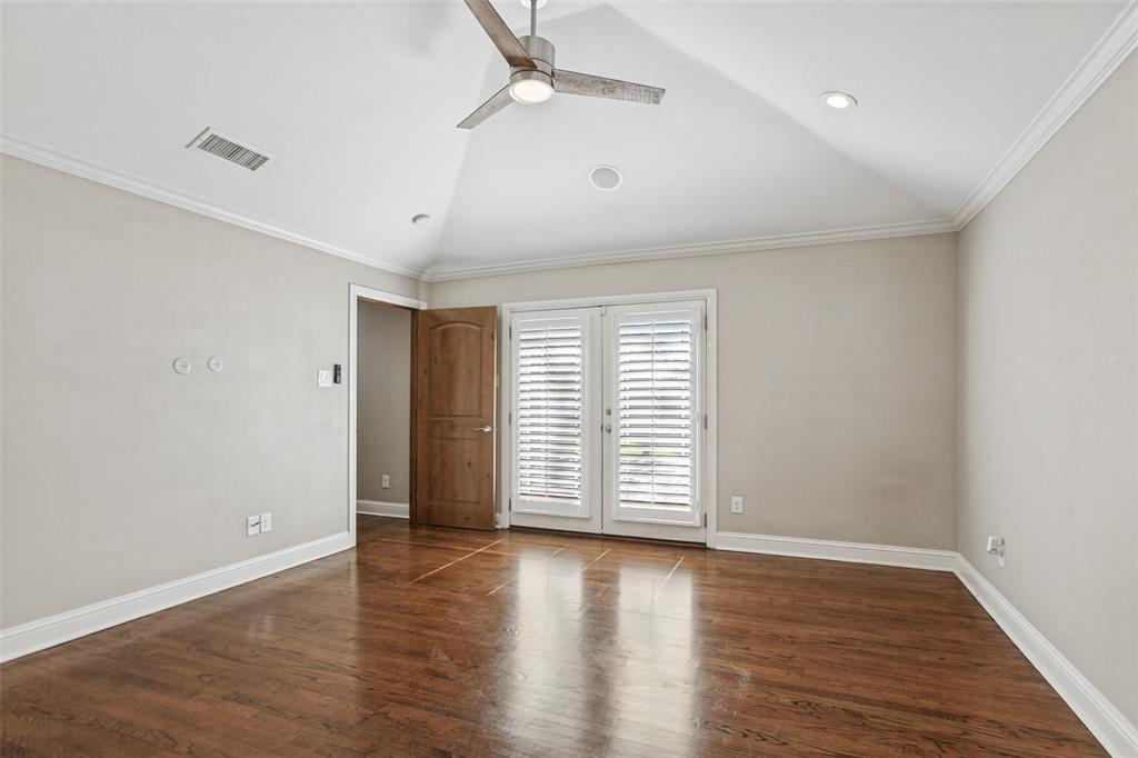 Spacious primary bedroom w vaulted ceilings and deck access