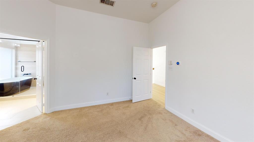 Room with high ceiling, neutral carpet flooring, and six-panel interior doors