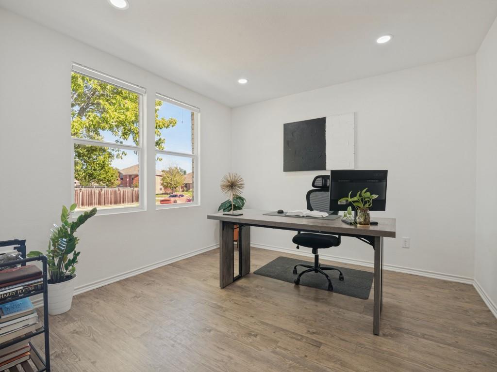 Neutral interior space featuring wood-finish flooring, dual windows, and recessed lighting