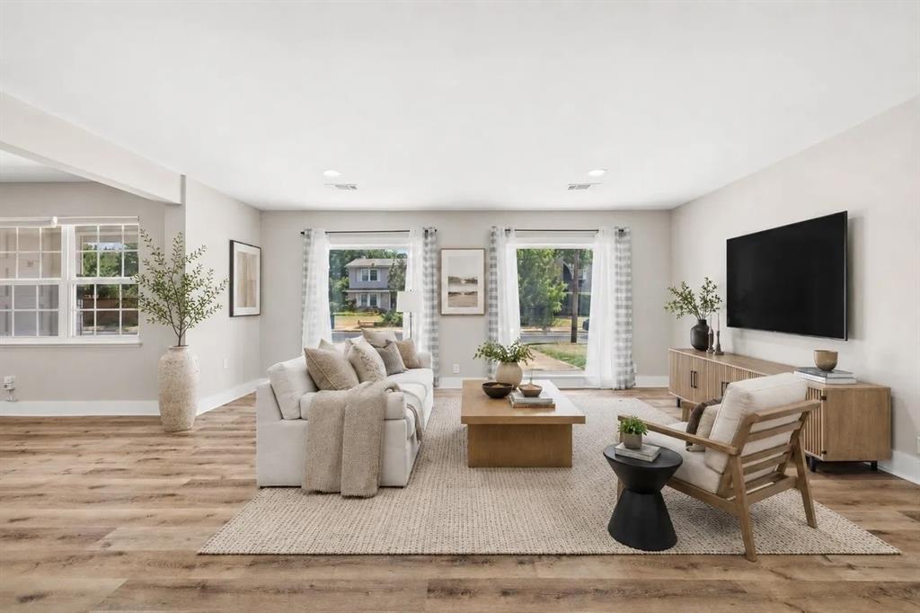 Neutral interior featuring wood-finish flooring, recessed lighting, and expansive windows Neutral interior featuring wood-finish flooring, recessed lighting, and expansive windows