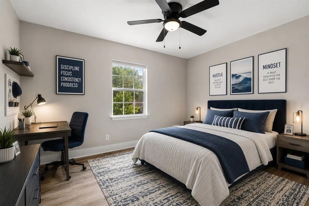 Neutral interior featuring wood-finish flooring, a multi-lite window, and a matte black ceiling fan with integrated lighting