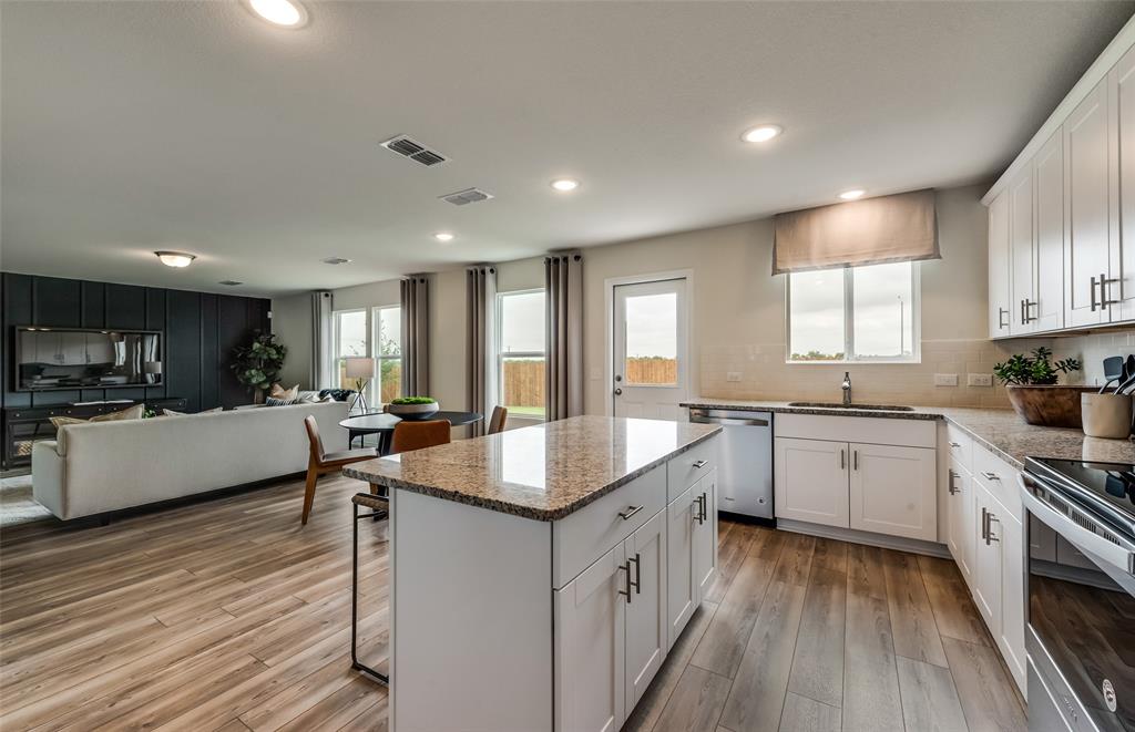 *Model Representation - Large island gathering room and dining areas overlooking