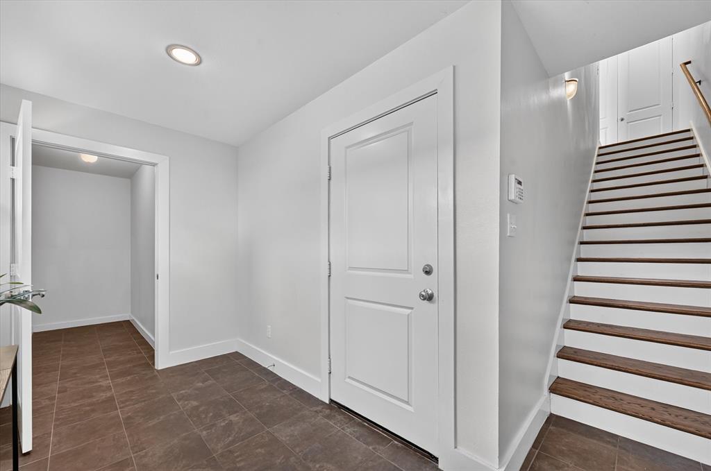 Entry way with large storage closet and door to 2 car garage