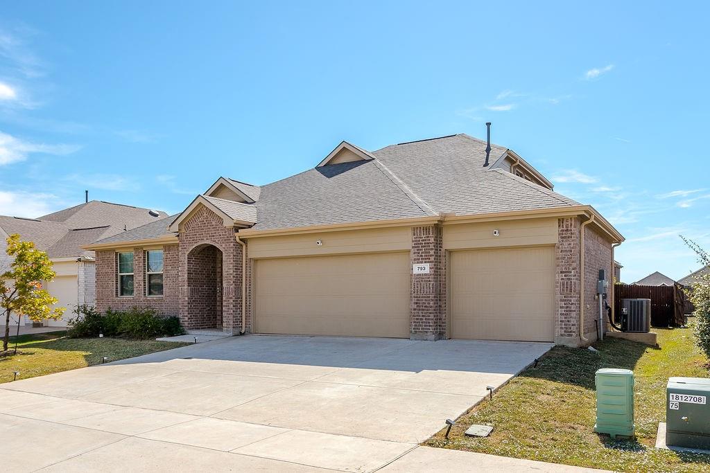 Exterior featuring a brick and siding facade, an arched covered entryway, a concrete driveway, and a three-car garage