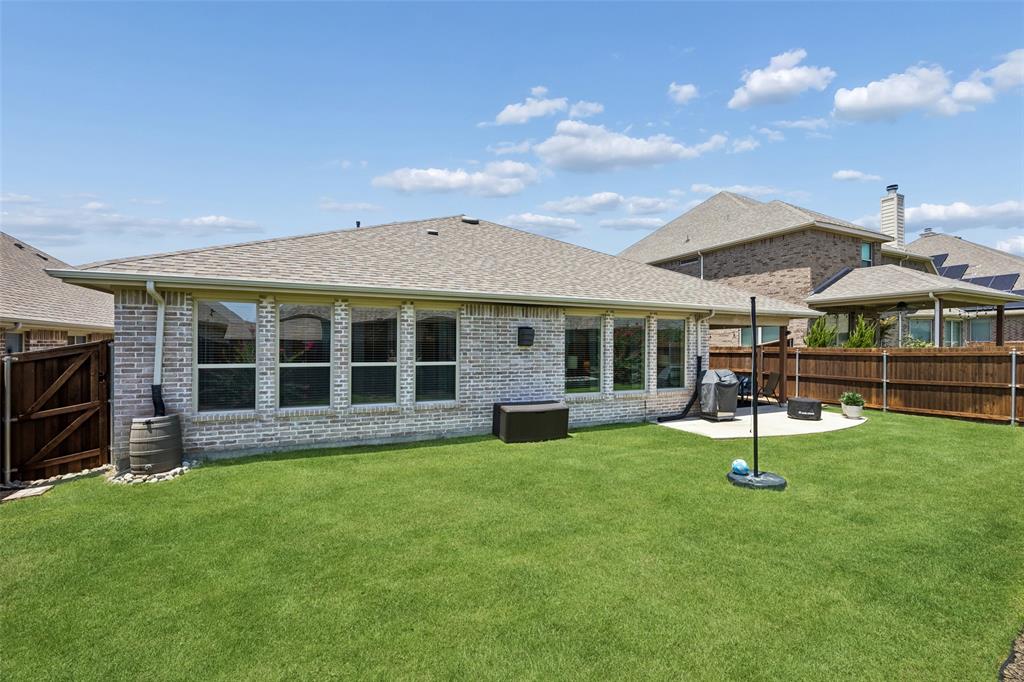 Large backyard with a wooden privacy fence.