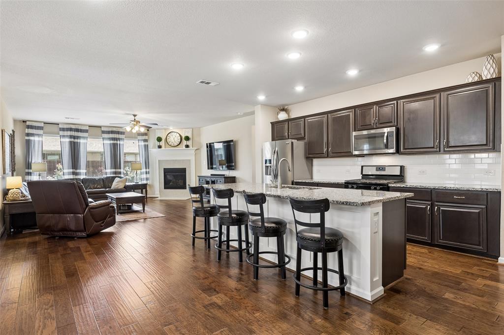 Open-concept living area and kitchen featuring a kitchen island with seating Open-concept living area and kitchen featuring a kitchen island with seating