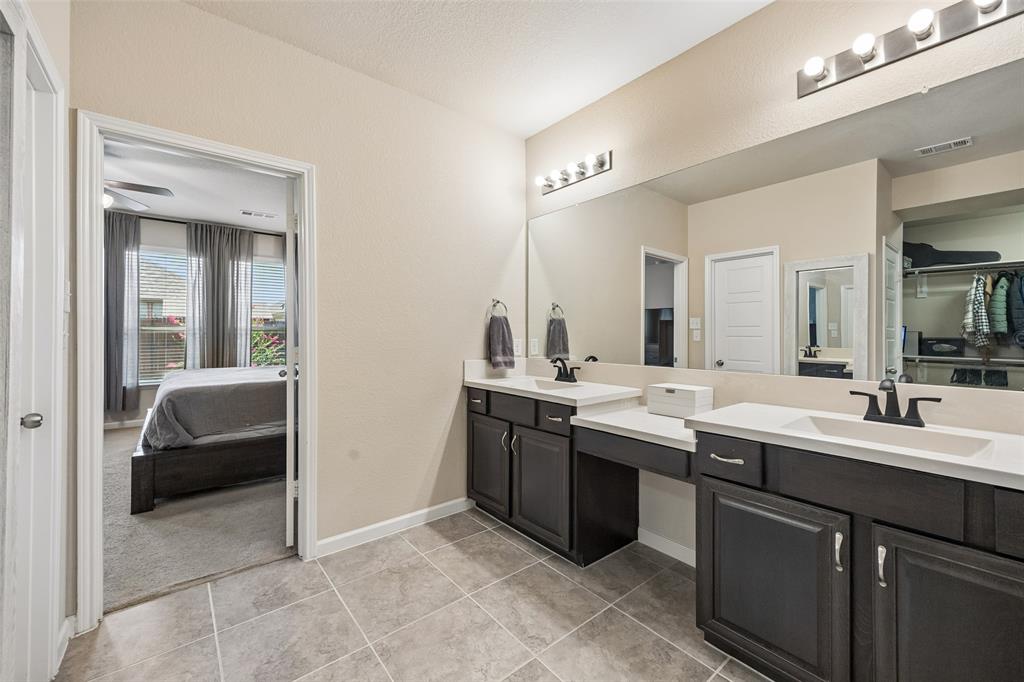 The large vanity features 2 sinks and a lower vanity sitting area.