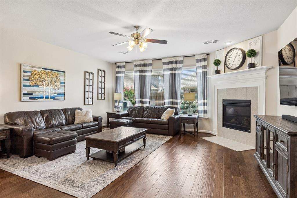 The living area features multiple windows with blinds