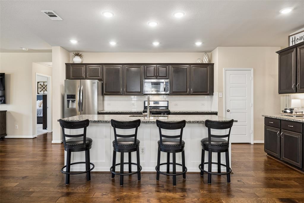 The oversized island has breakfast bar seating and a sink. The oversized island has breakfast bar seating and a sink.